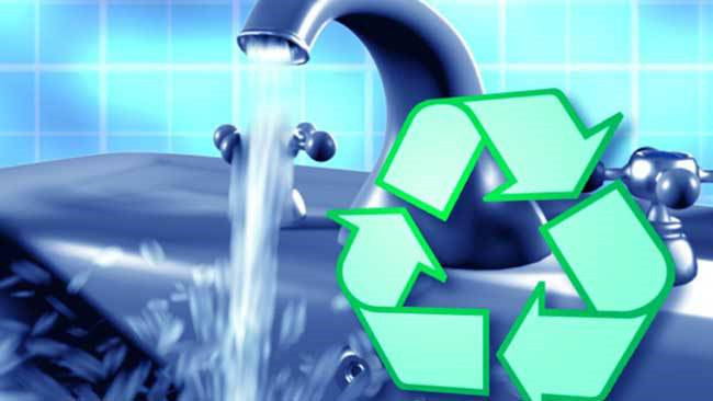 Water running from a faucet with a green recycling symbol overlaid, representing water conservation and environmental