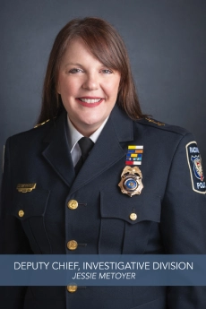 Official portrait of Deputy Chief Jessie Metoyer, Investigative Division, wearing a police uniform and smiling.
