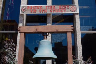 Racine Fire Department bell and sign at 610 8th Street. Bell is light blue-green.