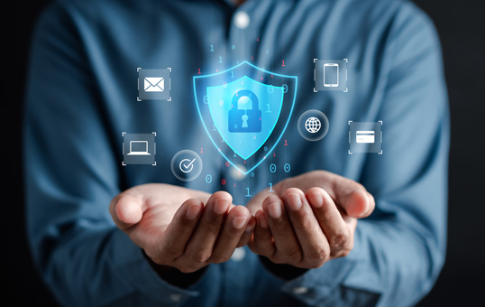 Person holding a digital shield with a padlock inside, surrounded by device icons, representing data security.