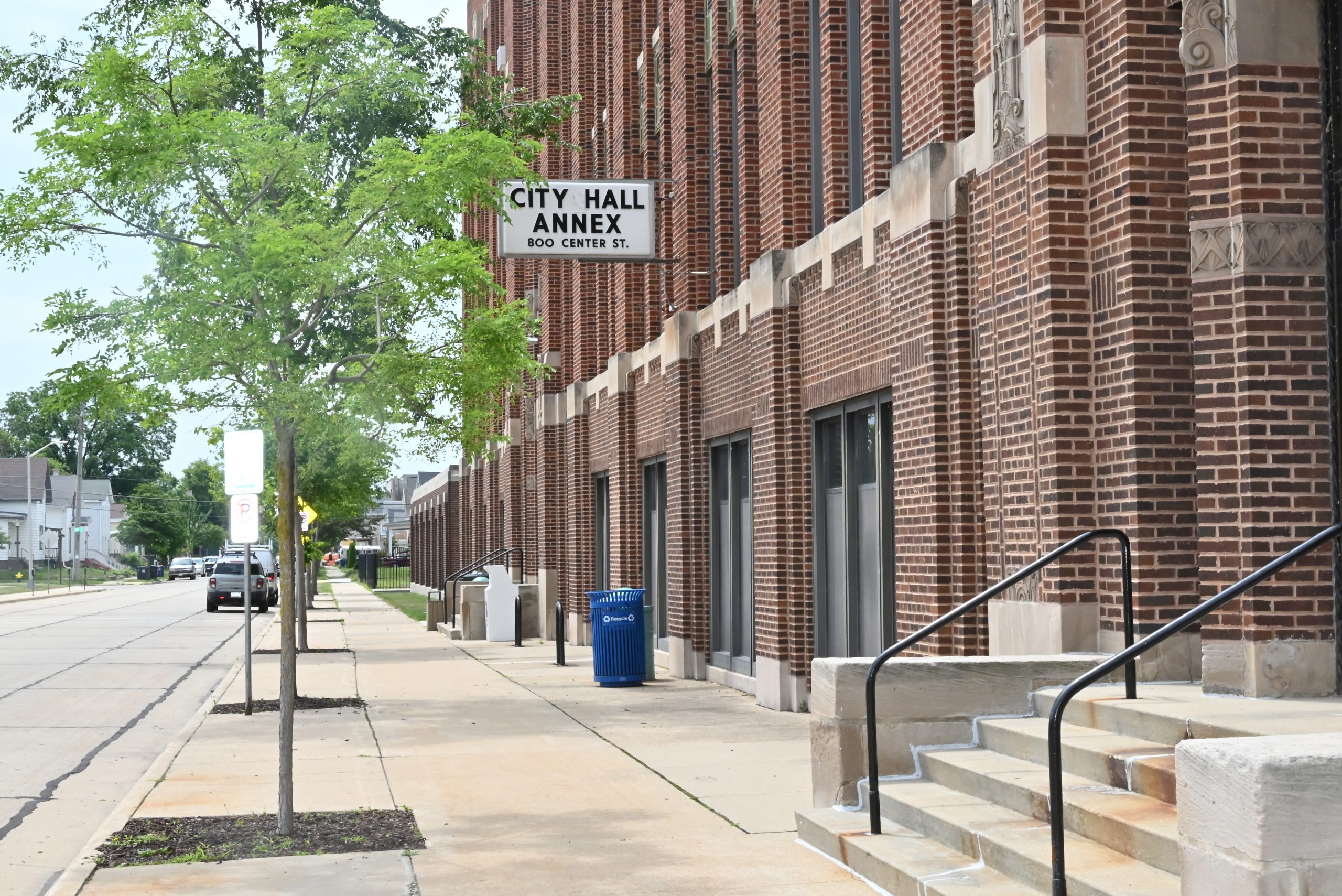 City Hall Annex building exterior with sign, sidewalk, and street view.