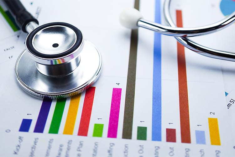 Colorful column chart with a stethoscope laid on top.